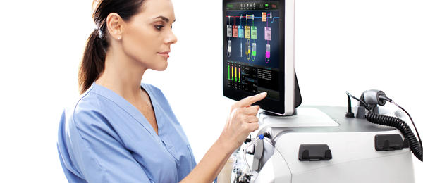 nurse interacting with the interface of the Prismax machine