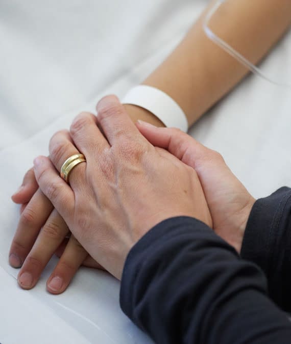 Loved one holding a Patient's hand